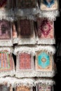 Vertical shot of various small prayer rugs at a souvenir shop