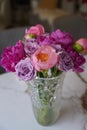 Vertical shot of a vase full of velvet and pink rose and Chinese herbaceous peony flowers on a table Royalty Free Stock Photo