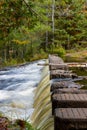 Vertical shot of the Victoria Dam in a park in autumn in Michigan, the US