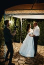 Vertical shot of a videographer with a Sony camera recording the wedding dance in Sarajevo