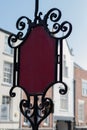 Vertical shot of a vintage metal red and black decoration in the middle of the street Royalty Free Stock Photo