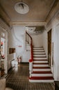 Vertical shot of a vintage room with red stairs leading up