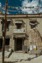 Vertical shot of a vintage stone building with a cafe in Ladakh, India