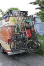 Vertical shot of a vintage van with a bicycle and tools fixed behind it