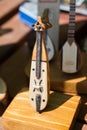 Vertical shot of a vintage violin on a wooden stand captured in an antique store