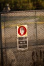 Vertical shot of the warning sign on the metal fence. Trespassers will be prosecuted.