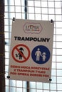 Vertical shot of warning signs with symbol with Polish text inside the Lider indoor playground.