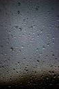 Vertical shot of water droplets of glass surface Royalty Free Stock Photo