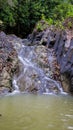 Vertical shot of a waterfall flowing over huge rocks Royalty Free Stock Photo