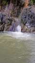 Vertical shot of a waterfall flowing over huge rocks Royalty Free Stock Photo