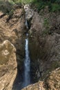 Vertical shot of a waterfall near the Popocatle basement in Mexico Royalty Free Stock Photo