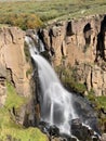 Vertical shot of a waterfall in the wild nature Royalty Free Stock Photo