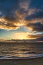 Vertical shot of waves crashing the shore at sunset, cool for abckground