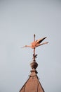 Vertical shot of a weathervane on a tower of a building