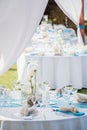 Vertical shot of wedding reception table in white and blue at an outdoor venue Royalty Free Stock Photo