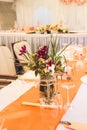 Vertical shot of wedding table decorations with beautiful floral compositions