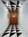 Vertical shot of a well-lighted tiled corridor with wooden door with rhombus window