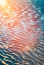 Vertical shot of the wet sands on the beach captured in Vrouwenpolder, Netherlands