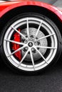 Vertical shot of the wheel of a Ferrari 812 Superfast with a carbon ceramic brake rotor