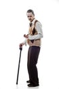 Vertical shot of a white Caucasian man in a grandfather costume holding a walking stick Royalty Free Stock Photo