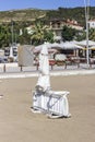 Vertical shot of white sunbed on the coastline at summertime