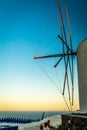 Vertical shot of windmill wings at the coast of a sea