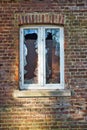 Vertical shot of a window with broken glass Royalty Free Stock Photo
