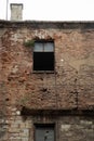 Vertical shot of a window on an old weathered brick wall Royalty Free Stock Photo