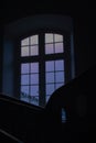 Vertical shot of a window overlooking a cloudy sky