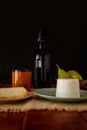 Vertical shot of a wine bottle, pears, glass, rice, and sl on the table Royalty Free Stock Photo