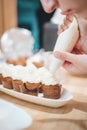 Vertical shot of a woman baking pastery in her house