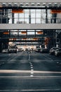 Vertical shot of a woman crossing the road with cars during heavy traffic in downtown Calgary