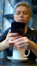 Vertical shot. a woman takes off her wedding ring, read the message on the phone Royalty Free Stock Photo