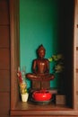 Vertical shot of a wooden Buddha statue in lotus meditation position Royalty Free Stock Photo