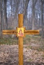Vertical shot of wooden cross with icon of Holy Martyrs Faith, Hope, Love and their mother Sophia