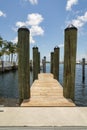 Vertical shot of a wooden dock with log posts at the bay in Miami, Florida Royalty Free Stock Photo