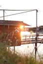 Vertical shot of a wooden hut on the shore of the Rhine river at sunset, Basel