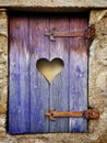 Vertical shot of a wooden shutter with a heart-shaped hole Royalty Free Stock Photo