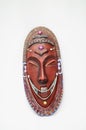 Vertical shot of a wooden voodoo traditional African mask on a white background