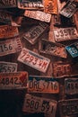 Vertical shot of a wooden wall full of license plates