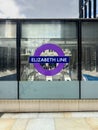 Vertical shot of the words "ELIZABETH LINE" displayed on the window in a train station in the UK