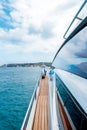 Vertical shot from the yacht of the sea under a blue cloudy sky Royalty Free Stock Photo