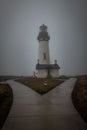 Vertical shot of the Yaquina Head Lighthouse on foggy rainy day Royalty Free Stock Photo