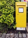 Vertical shot of a yellow letterbox found in the city of Brilon, Germany