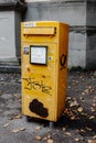 Vertical shot of a yellow mailbox in Konstanz, Germany