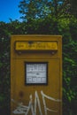 Vertical shot of yellow post box for only love letters written in german Royalty Free Stock Photo