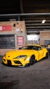 Vertical shot of a yellow Toyota Supra with modern design