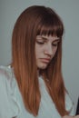 Vertical shot of a young Caucasian female portrait with a thoughtful expression Royalty Free Stock Photo