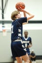 Vertical shot of a young male player on the court at a fall Merrillville high school basketball game Royalty Free Stock Photo