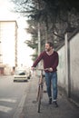 Vertical shot of a young male riding a bicycle on the sidewalk Royalty Free Stock Photo